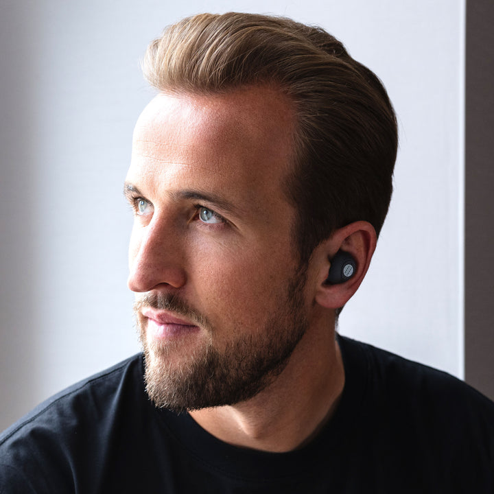 Harry Kane Football Star with Our Pure Planet 700XHP Earpods in his ears